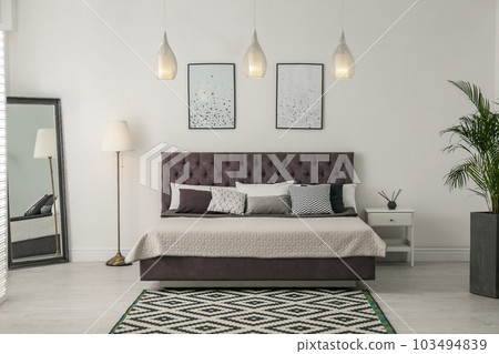 Elegant interior of modern comfortable bedroom with mirror 103494839