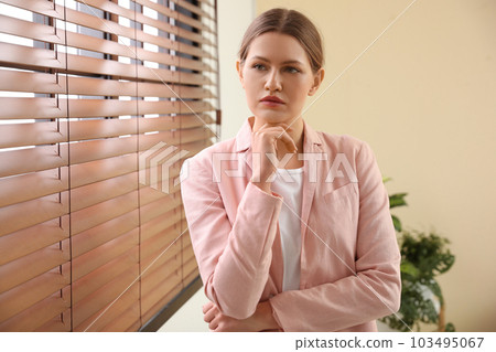 Professional psychotherapist near window in modern office 103495067