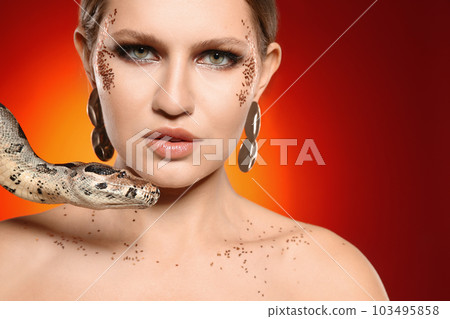 Beautiful woman with boa constrictor on bright colorful background, closeup 103495858