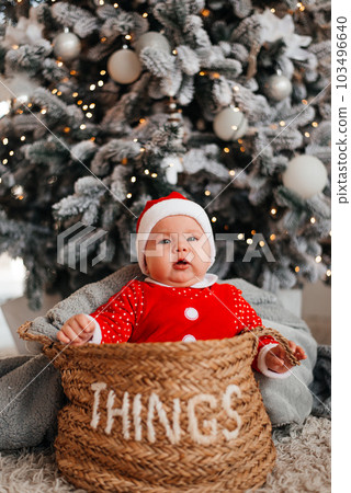 Baby on the background of a Christmas tree 103496640
