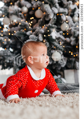 Baby on the background of a Christmas tree Baby on the background of a Christmas tree 103496643