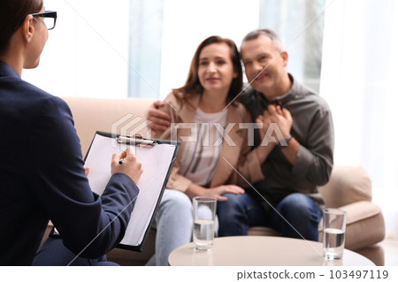 Psychotherapist and happy couple having meeting in office. Family counselling 103497119
