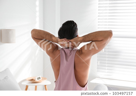 Man awakening on bed at home. Lazy morning 103497157
