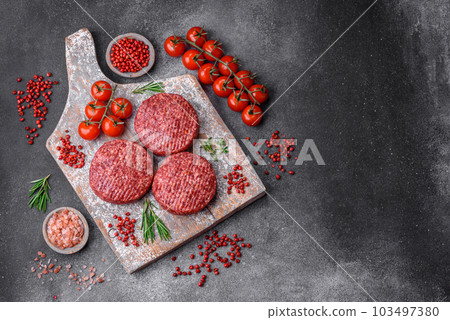 Fresh raw ground beef burger patty with salt and spices 103497380