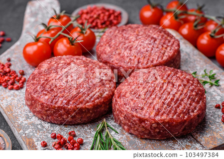 Fresh raw ground beef burger patty with salt and spices Fresh raw ground beef burger patty with salt and spices 103497384