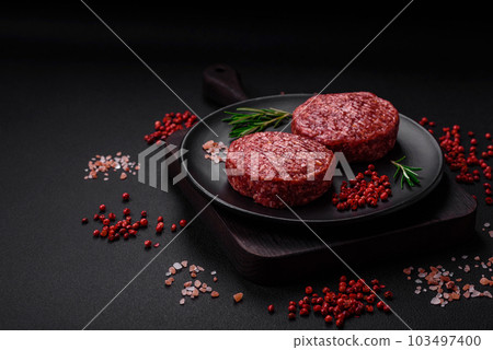 Fresh raw ground beef burger patty with salt and spices Fresh raw ground beef burger patty with salt and spices 103497400