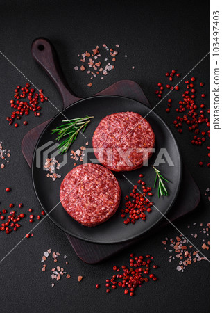 Fresh raw ground beef burger patty with salt and spices Fresh raw ground beef burger patty with salt and spices 103497403