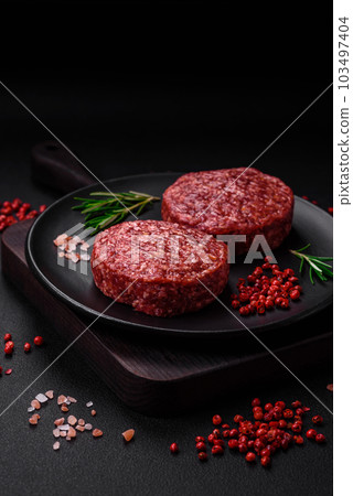 Fresh raw ground beef burger patty with salt and spices Fresh raw ground beef burger patty with salt and spices 103497404