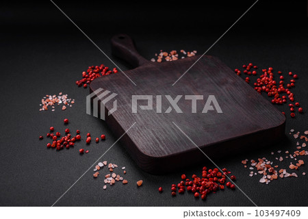 Empty wooden cutting board with thyme, spices, salt and herbs Empty wooden cutting board with thyme, spices, salt and herbs 103497409