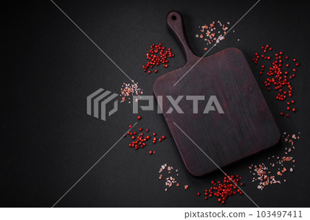 Empty wooden cutting board with thyme, spices, salt and herbs 103497411