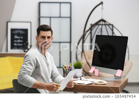 Male designer working at desk in office Male designer working at desk in office 103497454