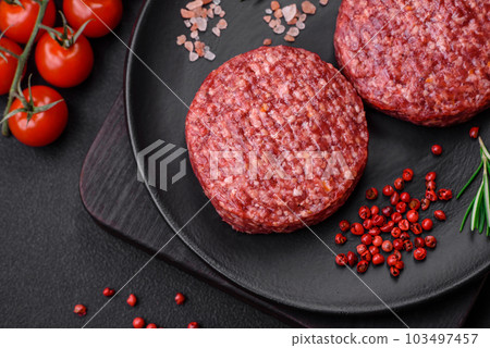 Fresh raw ground beef burger patty with salt and spices Fresh raw ground beef burger patty with salt and spices 103497457