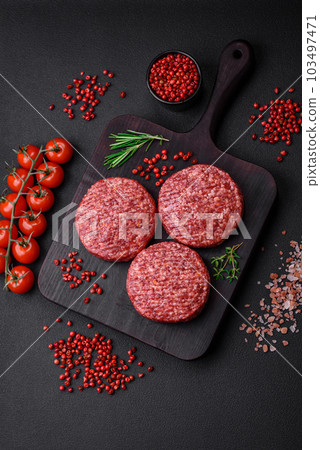 Fresh raw ground beef burger patty with salt and spices Fresh raw ground beef burger patty with salt and spices 103497471