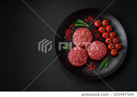 Fresh raw ground beef burger patty with salt and spices Fresh raw ground beef burger patty with salt and spices 103497504
