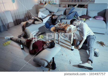 Drunk friends sleeping in messy room after party 103497757