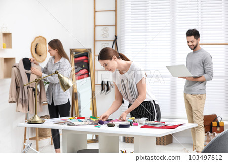 Fashion designers creating new clothes in studio Fashion designers creating new clothes in studio 103497812