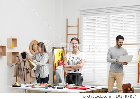 Fashion designers creating new clothes in studio Fashion designers creating new clothes in studio 103497814