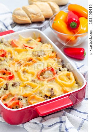 Casserole with potatoes, sausage and colorful bell pepper, in baking dish, vertical Casserole with potatoes, sausage and colorful bell pepper, in baking dish, vertical 103498416