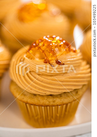 Freshly baked dulce de leche cupcakes on a kitchen counter. Freshly baked dulce de leche cupcakes on a kitchen counter. 103499225