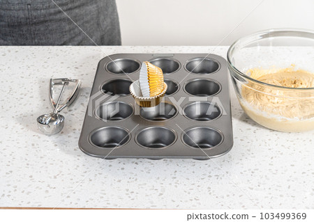 Premium Photo  Scooping cupcake batter with dough scoop into a