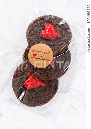 Chocolate cookies with chocolate hearts for Valentine's Day packaged in plastic gift bags. Chocolate cookies with chocolate hearts for Valentine's Day packaged in plastic gift bags. 103499581