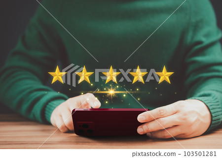 Man's hand using a smartphone and give five star symbol to increase rating of product and service concept, Customer service experience, testimonial and business satisfaction survey. 103501281