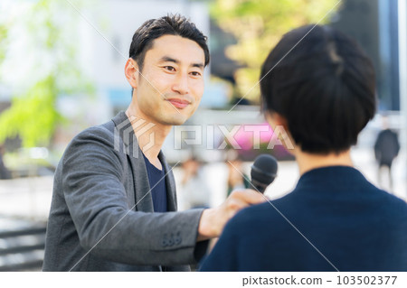 Reporter interviewing on the street Reporter interviewing on the street 103502377