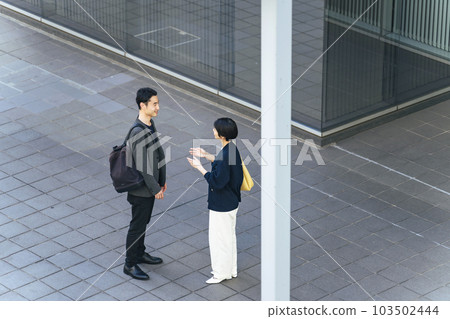 A bird's eye view of men and women talking in the city 103502444