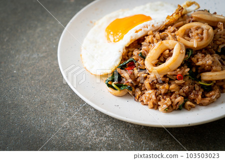 fried rice with squid and basil topped fried egg in Thai style fried rice with squid and basil topped fried egg in Thai style 103503023