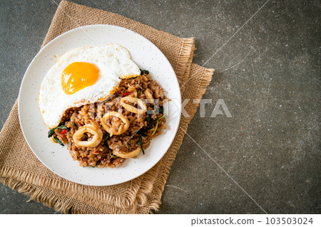 fried rice with squid and basil topped fried egg in Thai style fried rice with squid and basil topped fried egg in Thai style 103503024