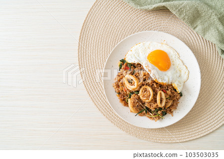 fried rice with squid and basil topped fried egg in Thai style fried rice with squid and basil topped fried egg in Thai style 103503035