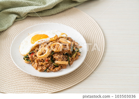 fried rice with squid and basil topped fried egg in Thai style fried rice with squid and basil topped fried egg in Thai style 103503036