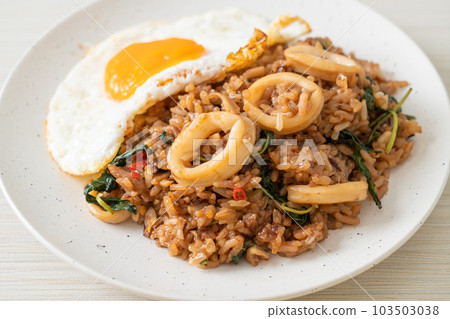 fried rice with squid and basil topped fried egg in Thai style fried rice with squid and basil topped fried egg in Thai style 103503038