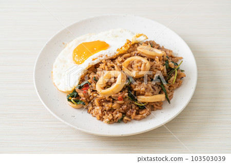 fried rice with squid and basil topped fried egg in Thai style fried rice with squid and basil topped fried egg in Thai style 103503039
