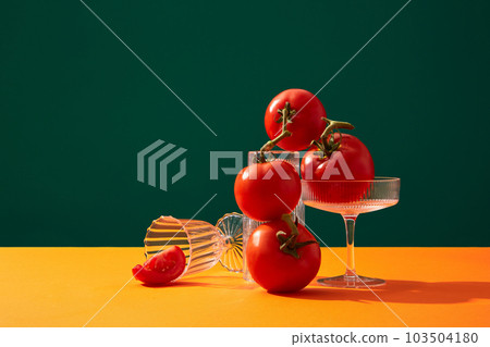 Luxury composition of fresh tomatoes with glasses in various shapes. Tomato (Solanum lycopersicum) can be processed into juice to beautify the skin 103504180