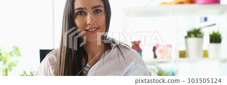 Beautiful woman is sitting on bed and holding diary Beautiful woman is sitting on bed and holding diary 103505124