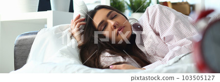 Sleepy woman with closed eyes dreaming about future vacation or sleeping in the bedroom 103505127