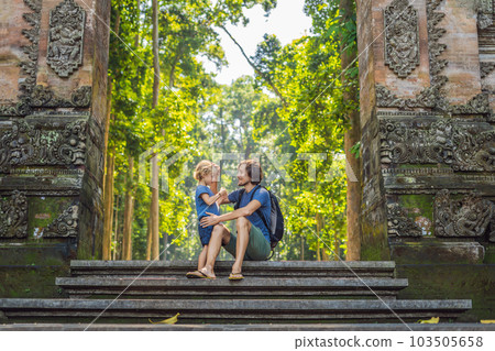 Dad and son travelers discovering Ubud forest in Monkey forest, Bali Indonesia. Traveling with children concept 103505658