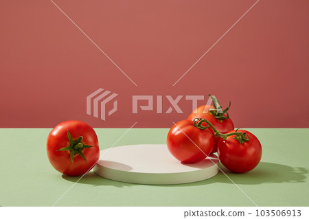 Abstract background with minimalist style for product brand presentation - against a color background, a round white podium decorated with fresh tomatoes. Front view, copy space 103506913