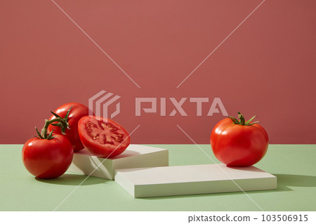 Cylinder white podiums decorated with ripe fresh tomatoes on pink background. Minimal empty display product presentation scene. Summer fruit concept. Cylinder white podiums decorated with ripe fresh tomatoes on pink background. Minimal empty display product presentation scene. Summer fruit concept. 103506915