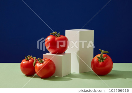 Scene for display of organic natural cosmetic products - empty podium and fresh tomatoes on a color background. Blank space to display packaging mockup Scene for display of organic natural cosmetic products - empty podium and fresh tomatoes on a color background. Blank space to display packaging mockup 103506916