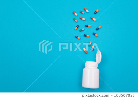 Pharmaceutical Industry and Medicinal Products - Colored Pills on Blue Table 103507055