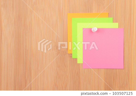 Colored Sticky Notes Pinned to the Wooden Message Board Colored Sticky Notes Pinned to the Wooden Message Board 103507125