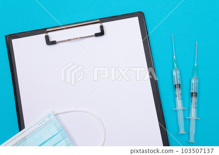 Vaccination or Revaccination Concept - Two Medical Syringe on Blue Table Vaccination or Revaccination Concept - Two Medical Syringe on Blue Table 103507137