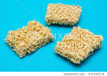 Uncooked Instant Noodles on Blue Background Uncooked Instant Noodles on Blue Background 103507138