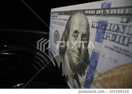 Dollar banknote on counter machine in banking institution 103509328