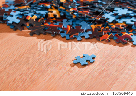 Mixed Jigsaw Puzzle Peaces on Wooden Table Mixed Jigsaw Puzzle Peaces on Wooden Table 103509440
