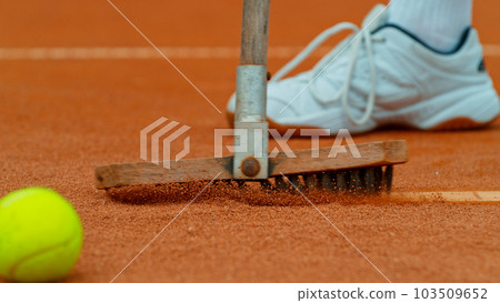 Cleaning marking line clay tennis court with brush. Clay tennis court cleaning. Cleaning marking line clay tennis court with brush. Clay tennis court cleaning. 103509652