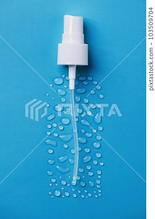Drops of face serum top view. Liquid gel moisturizer. Creative idea of face serum with pipette on blue background. Drops of face serum top view. Liquid gel moisturizer. Creative idea of face serum with pipette on blue background. 103509704