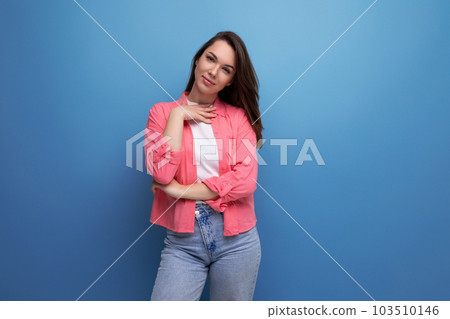 portrait of a young woman with hair below her shoulders in jeans and a shirt portrait of a young woman with hair below her shoulders in jeans and a shirt 103510146